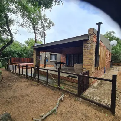 a house with a fence in front of it at Six Senses in Marloth Park