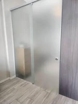a room with a glass door and a wooden floor at Menlyn Maine Residences 1317 in Pretoria
