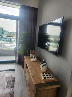 a living room with a flat screen tv on a wall at Menlyn Maine Residences 1317 in Pretoria