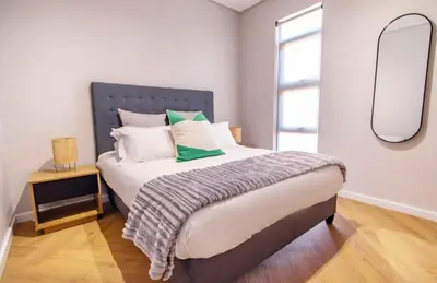 a bedroom with a large bed with a mirror at Madumane Self Catering in Hildreth Ridge