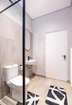 a bathroom with a toilet and a sink and a mirror at Madumane Self Catering in Hildreth Ridge
