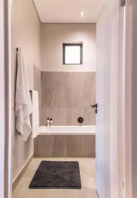 a bathroom with a shower and a tub and a sink at Madumane Self Catering in Hildreth Ridge