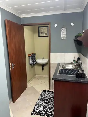 a bathroom with a sink and a sink at Cloete Self catering Guest room in Ermelo