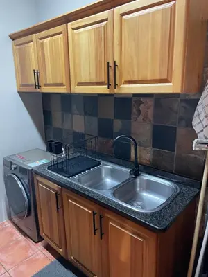 a kitchen with a sink and a washing machine at Botterblom Hide-Away in Sabie