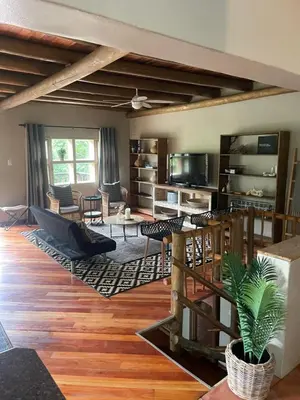a living room with a couch and a table at Botterblom Hide-Away in Sabie