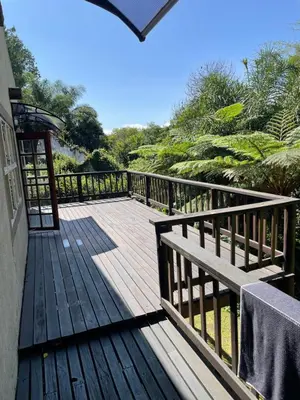 a wooden deck with a bench on top of it at Botterblom Hide-Away in Sabie
