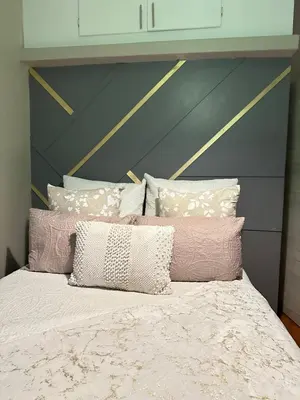 a bed with pink and white pillows on it at The Loraine Luxury Villa in Witbank