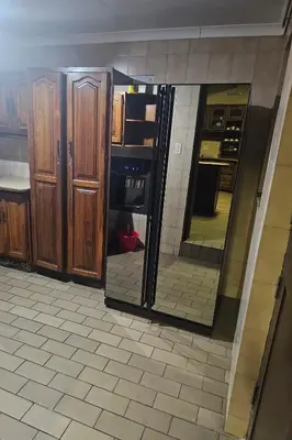 a kitchen with a large mirror in a room at The Loraine Luxury Villa in Witbank