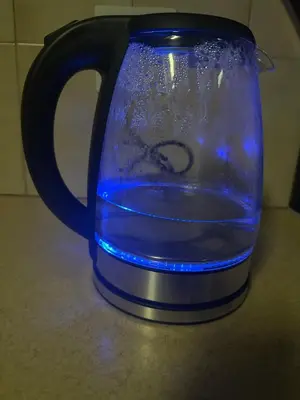 a blue glass jug filled with water on a counter at The Loraine Luxury Villa in Witbank