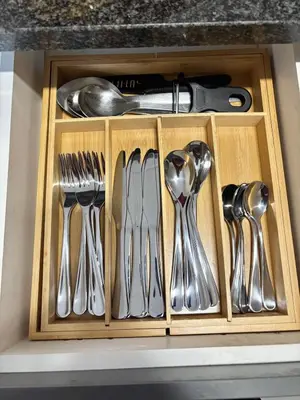 a drawer with silver utensils in it at The Place at Waterfall in Midrand