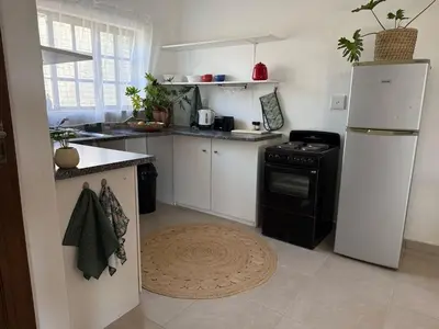 a kitchen with a white refrigerator and a stove at Wittus Retreat in White River