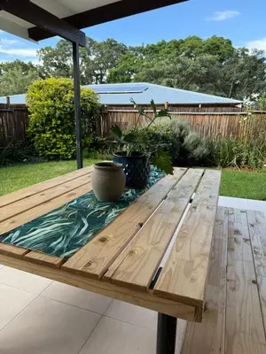 a wooden picnic table with a vase sitting on it at Wittus Retreat in White River
