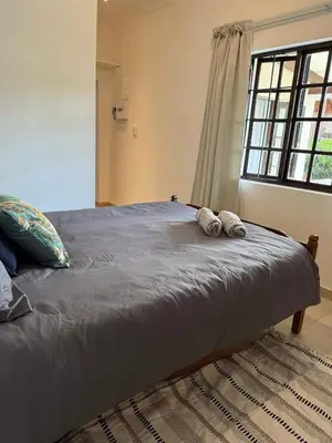 a bed with two pillows on it in a bedroom at Wittus Retreat in White River