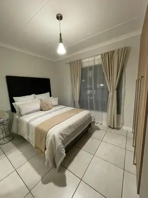 a bedroom with a large bed and a window at The Blyde Crystal Lagoon in Pretoria