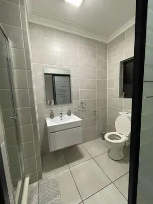 a bathroom with a toilet and a sink at The Blyde Crystal Lagoon in Pretoria