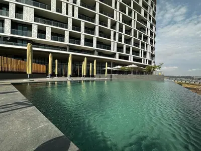 a large building with a pool of water in front of it at Stunning 2 bedroom condo at Ellipse Midrand in Midrand