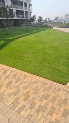 a field of green grass next to a building at Stunning 2 bedroom condo at Ellipse Midrand in Midrand