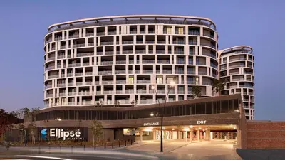 a large white building with a store in front of it at Stunning 2 bedroom condo at Ellipse Midrand in Midrand