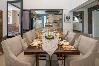 a dining room with a table and chairs at Grace House, Mkhuhlu, spacious 4-bedroom house in Belfast