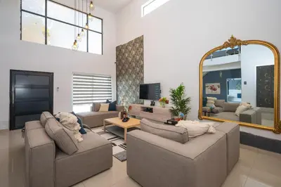 a living room with two couches and a mirror at Grace House, Mkhuhlu, spacious 4-bedroom house in Belfast