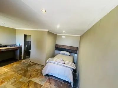 a bedroom with a bed in the corner of a room at Stonehouse in Carolina