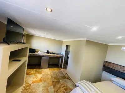 a room with a bed and a desk in it at Stonehouse in Carolina