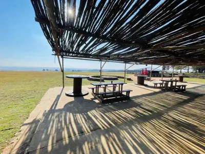 a group of picnic tables and benches under a roof at Stonehouse in Carolina
