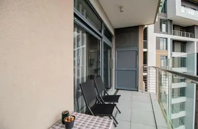 a balcony with two chairs and a table on a building at Luxury AT Maine in Pretoria
