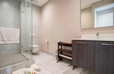 a bathroom with a shower and a sink and a toilet at Luxury AT Maine in Pretoria