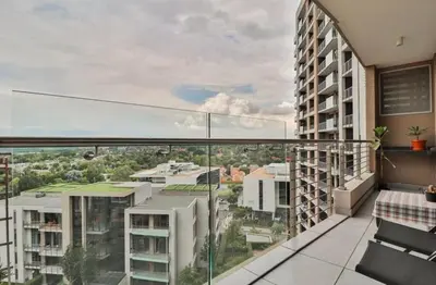 an apartment balcony with a view of a city at Luxury AT Maine in Pretoria