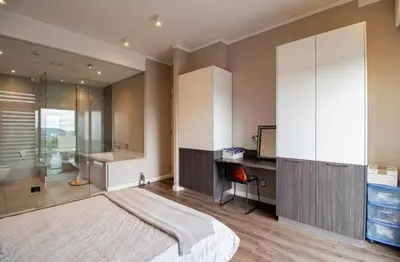 a bedroom with a large bed and a shower at Luxury AT Maine in Pretoria