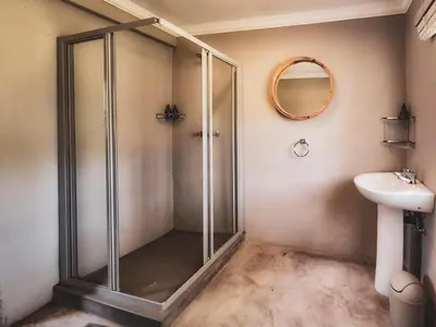 a bathroom with a shower and a sink at Die Skoen in Dinokeng Game Reserve