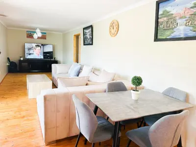 a living room with a couch and a table at The Man Cave in Sabie