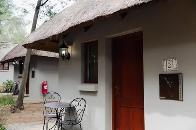 a building with a table and chairs and a door at Ingaadi in Pretoria
