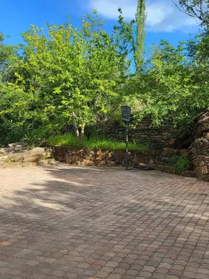 a stone wall with a street sign next to a tree at Irene Villa in Irene