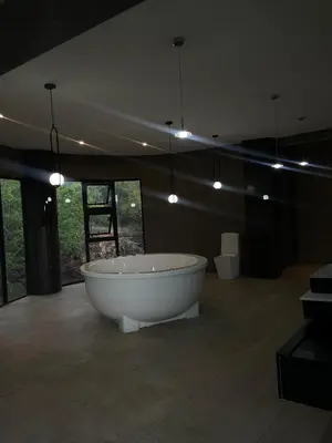 a white bath tub in a room with lights at Irene Villa in Irene