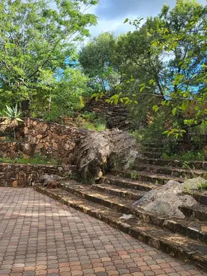 a set of stone steps next to a stone wall at Irene Villa in Irene