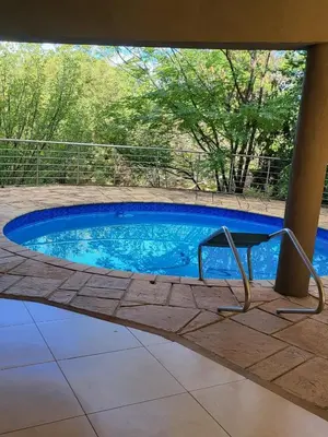 a small swimming pool in a yard with at Irene Villa in Irene