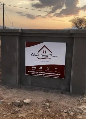 a sign for a real estate guest house on a wall at Okuhle guesthouse in Mahlakwena
