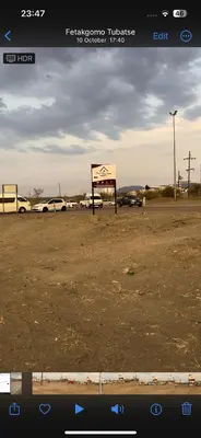 a view of a parking lot with cars in a field at Okuhle guesthouse in Mahlakwena