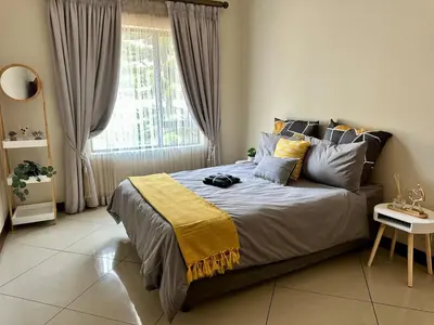 a bedroom with a large bed with a window at The Ridge At Mountain View Vacation Home in Boschrand