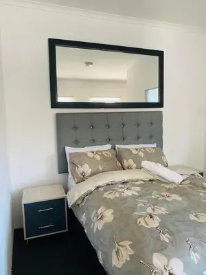 a bedroom with a bed with a mirror above it at Linies guest house in Benoni