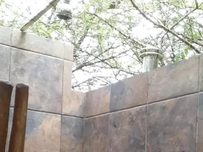 a concrete wall with a light on top of it at My Bush Camp in Settlers