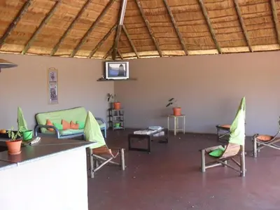a living room with chairs and a table and a couch at My Bush Camp in Settlers