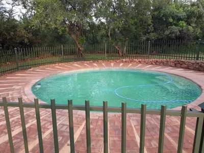 a small swimming pool with a fence around it at My Bush Camp in Settlers