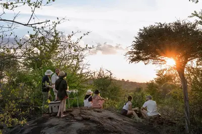 a group of people sitting on top of a rock at Sashwa River of Stars Plant-Based Wellness Safari Lodge in Hoedspruit