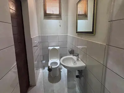 a bathroom with a toilet and a sink at The Pillows Suites Villa in Pretoria