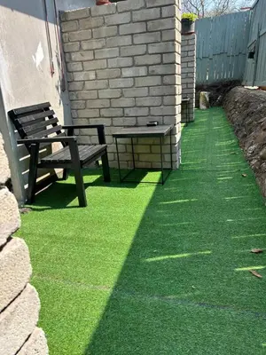 a bench sitting on the grass next to a building at Sherotha Homestay in Louis Trichardt