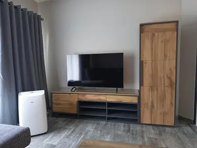 a entertainment center with a flat screen tv in a room at Hantam Suites in Centurion