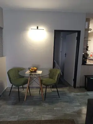 a table with two chairs and a bowl of fruit on it at Hantam Suites in Centurion
